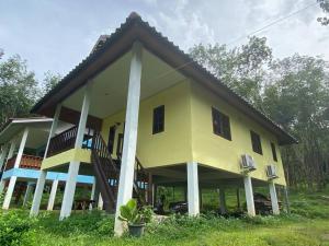 a large yellow house with a gambrel roof at 2 Bed Sunset Seaview Good View House Y in Ko Yao Noi