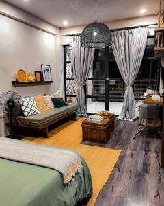 a bedroom with a bed and a room with curtains at El Nido Boutique Vacation Villas in El Nido