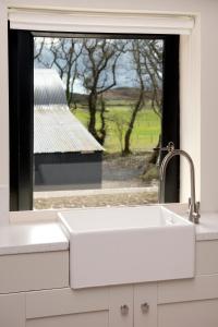 a kitchen sink and a window with a view of a barn at K2Cottages 