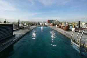a swimming pool on the roof of a building at HÔTEL De SOURIANT Premium Hanoi in Hanoi