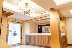 a lobby with a chandelier in a building at Elegance Hotel in Taipei