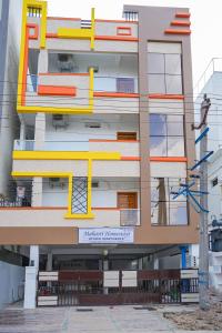 a building with yellow and orange paint on it at MAHASRI Studio Apartments- Brand New Fully Furnished Air Conditioned Studio Apartments in Tirupati