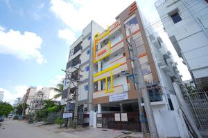 a building with a yellow sign on the side of it at MAHASRI Studio Apartments- Brand New Fully Furnished Air Conditioned Studio Apartments in Tirupati