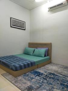 a bed in a room with a blue mattress at D'Port DicksonMuslimOnly Homestay in Port Dickson
