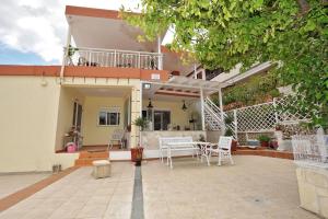 a house with a patio with a table and chairs at MARIA NEFELI SEA VIEW in Afitos