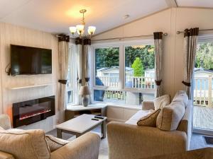 a living room with two couches and a fireplace at Elm Lodge in Ilfracombe
