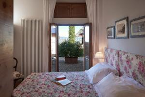 a bedroom with a bed with a book on it at I Casaloni in Panzano