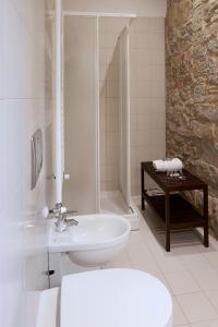 a white bathroom with a sink and a shower at I Casaloni in Panzano