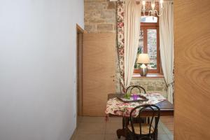 a dining room with a table and chairs and a window at I Casaloni in Panzano +18 photos
