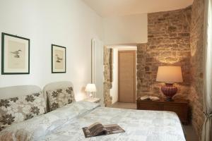 a bedroom with a bed with a book on it at I Casaloni in Panzano
