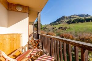 a balcony with chairs and a view of a mountain at Hypercenter at the foot of the slopes in Le Grand-Bornand