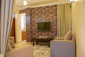 Μια τηλεόραση ή/και κέντρο ψυχαγωγίας στο Pearl Suites Apartments +11 φωτογραφίες