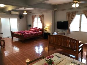 a living room with a couch and a television at Apartment kata in Kata Beach