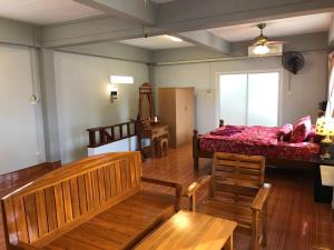 a room with a bed and benches and a window at Apartment kata in Kata Beach