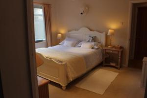 una camera da letto con un grande letto bianco e una finestra di Apartment with own entrance & terrace on West Hill a Hastings