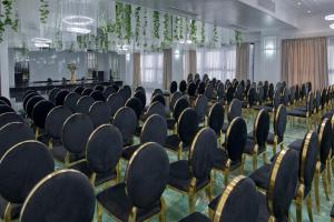 a row of chairs in a room with plants at Hotel Terra Balneo in Galaţi +87 photos