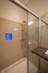 a shower with a glass door in a bathroom at Levestate Apartments Klährgasse Vol 1 in Vienna