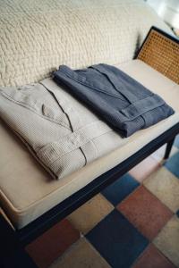 a pair of jeans sitting on top of a bed at Casa N in Arona