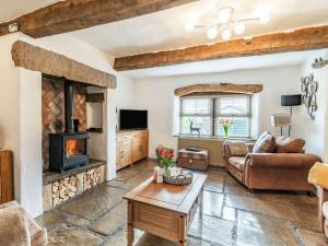 a living room with a couch and a fireplace at Tynedale in Padiham