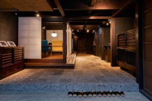 a hallway with a row of bowling shoes on the floor at 茜さす 肥前浜宿 Akanesasu Hizenhamashuku in Hama