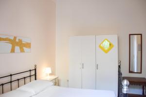 a bedroom with a bed and a cabinet and a mirror at sleep easy in Florence
