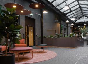 a lobby with chairs and plants in a building at Citybox Oslo in Oslo