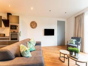 a living room with a couch and a table at Modern holiday home in Goirle with sauna in Goirle