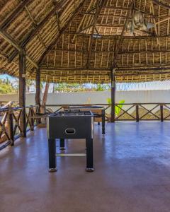 a ping pong table in the middle of a building at Mawe Zuri Resort in Watamu