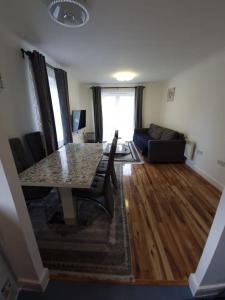 a living room with a table and a couch at 2 bedroom flat in SW London in Sutton