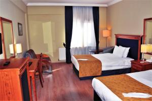 A bed or beds in a room at The Green Park Kartepe