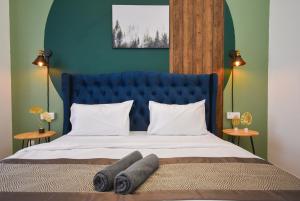 uma cama com cabeceira azul e almofadas brancas em Sunway Grid Loft Suite by Nest Home【Olympic Size Pool】 em Kampong Pendas