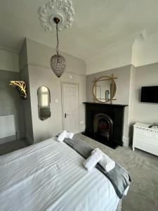 a bedroom with a large bed and a fireplace at Grange Lodge in York