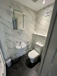 a bathroom with a white toilet and a sink at Grange Lodge in York