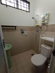 a bathroom with a toilet and a shower at The Handz House II with WIFI - For family or same gender only in Kepala Batas