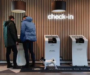 two people and a dog standing in front of a store at Citybox Oslo in Oslo