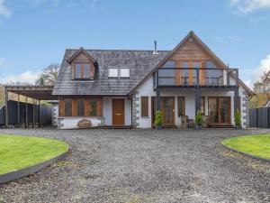 a large house with a driveway in front of it at Am Bruadar in Dalmally