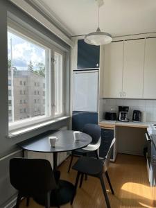 a kitchen with a table and chairs and a window at Studiohuoneisto Liisankatu in Lappeenranta
