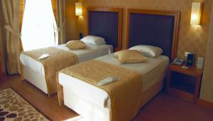 A bed or beds in a room at The Green Park Kartepe