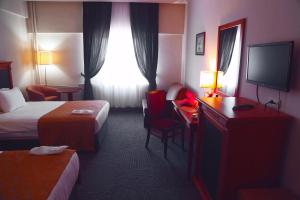 A bed or beds in a room at The Green Park Kartepe