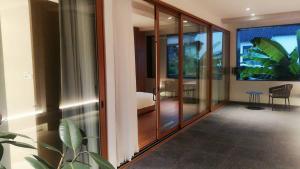 a room with sliding glass doors and a bedroom at Jiangnan House Jingwenli in Suzhou
