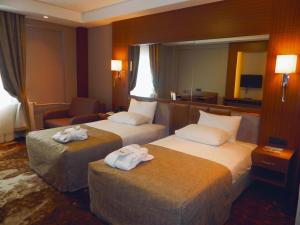 A bed or beds in a room at The Green Park Kartepe