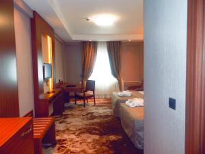 A bed or beds in a room at The Green Park Kartepe