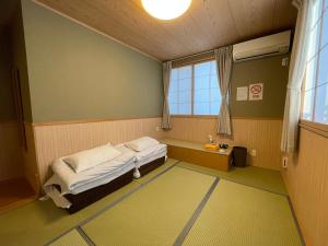 Postel nebo postele na pokoji v ubytování GuestHouse Guu