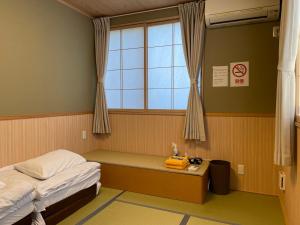 Postel nebo postele na pokoji v ubytování GuestHouse Guu