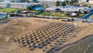 an overhead view of a group of umbrellas on a beach at Sol Marina Beach Crete in Gouves