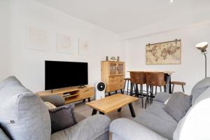a living room with two couches and a flat screen tv at Casa Manuela in Las Palmas de Gran Canaria