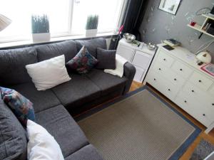 a living room with a gray couch and a white cabinet at Tampere, Teisko , Näsijärven rannalla 