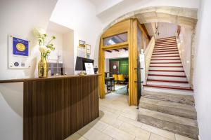 a hallway with a staircase and a lobby with a stair case at Bohemian Hotel in Regensburg