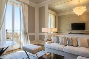 a living room with a couch and a table at Grand Hotel Principe Di Piemonte in Viareggio