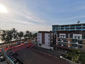 a view of a city with palm trees and buildings at The Sea Bangsaen Hotel in Ban Bang Saen (1)
